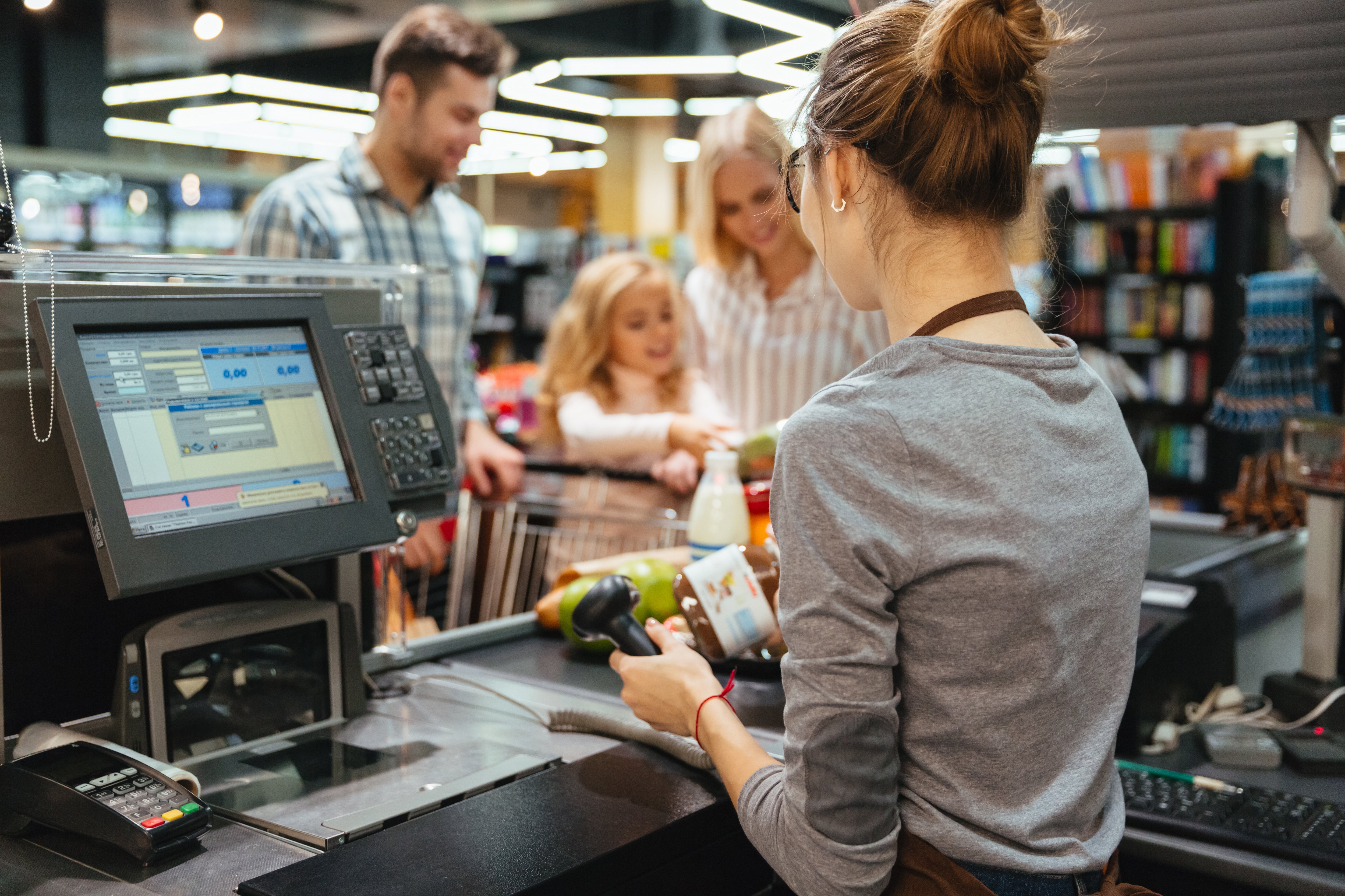 beautiful-family-standing-cash-counter